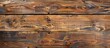 © meristock - An aged, scratched brown wooden board with knots provides a rustic texture for backgrounds or designs, perfect for a copy space image.