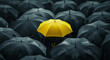 © Vika art - One yellow umbrella among black umbrellas.