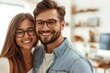 © Vera - Stylish Young Couple in Glasses Laughing Together in Casual Outfits, Man with Groomed Beard, White Background with Weekend Getaway and Remote Work Theme