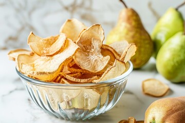 Wall Mural - Dehydrated pear chips in glass bowl with fresh green fruit on table