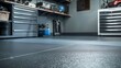 © Aeman - Cool slate grey rubber flooring in a garage, providing a modern and sophisticated surface for high-tech gadgets