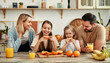 © Valerii Apetroaiei - A happy family bonding over breakfast in a cozy modern kitchen, enjoying a meal together