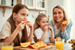 © Valerii Apetroaiei - Family in kitchen, enjoying fresh oranges, a moment of happiness and togetherness