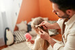 © Valerii Apetroaiei - Father braids daughters hair in a warm, snug room, cherishing a moment of bonding
