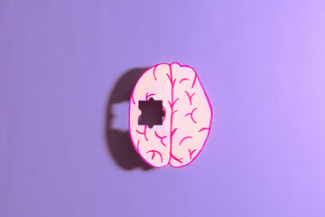 Wall Mural - Human brain anatomy missing a piece of jigsaw puzzle on purple background. Concept of Memory loss, dementia, Alzheimer's disease, Parkinson's disease and mental health.