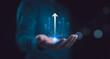 © Suriya - Hand holding growth business strategy arrow concept on success target improvement with increase development graph profit or economy investment income target and goal increase achievement.