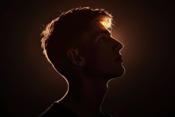 Wall Mural - Silhouette of the head and shoulders of an attractive young man in front of a black background, backlit, studio portrait Generative AI