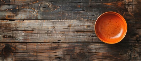 Aufkleber - Aerial perspective of a vacant orange dish on a wooden surface with copy space image.