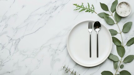 A white dinner plate sits on a marble tabletop with a cloth napkin beside it, along with two black forks and a knife