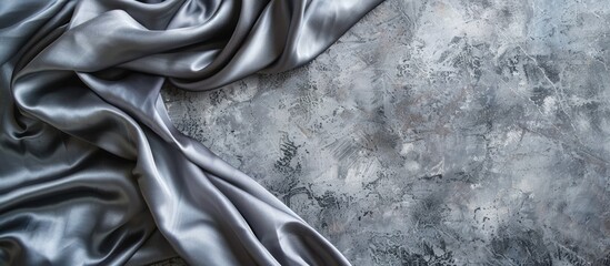 Aufkleber - Grey stone background with a piece of satin fabric creating an abstract effect, with copy space image.