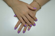 © Selman - Close-up of hand nails. Close-up of hand nails with purple nail polish. Personal care Beauty and elegance.