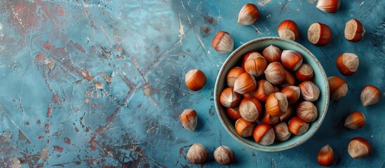 Poster - Hazelnuts displayed beautifully with a delicate background in a top view copy space image.