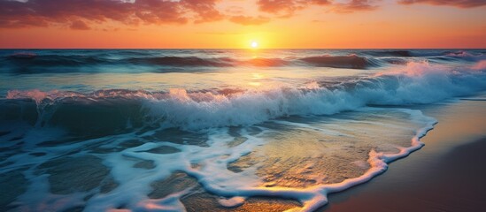 Poster - Sunset seascape with waves splashing on the shore, the sun reflecting on the sea, and clear sky, perfect for beach and nature concepts, has copy space image.