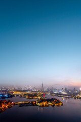 Wall Mural - Vibrant City Skyline at Sunset with Illuminated Buildings