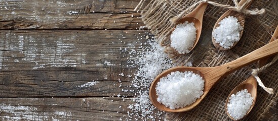 Poster - Sea salt spoons on a rustic wooden table with ample copy space image.