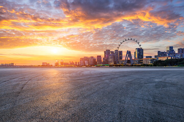 Poster - Asphalt road square and modern city buildings scenery at sunset. car advertising background.