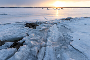 Wall Mural - landscape with frozen baltic sea on a sunset. cracked ice