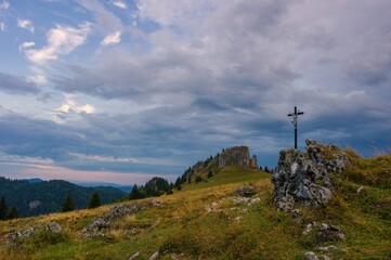 Wall Mural - Mountain landscape with rocks, pastures for cattle and a small cross in the foreground. Slovak mountain nature Velka Fatra, Kralova Studna