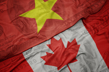 Wall Mural - waving colorful flag of vietnam and national flag of canada on the dollar money background. finance concept.