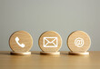 © Mahmud - Contact us concept. Wooden block with contact us icon or Customer support hotline people connect design