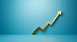 © IBEX.Media - Solid gold upward arrow on a blue background symbolizing growth and success