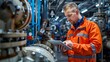 © thowithun - Engineer in orange jacket using tablet for maintenance and inspection inside an industrial facility with machinery and equipment