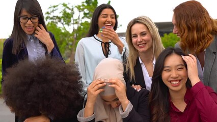 Sticker - Multiracial business women laughing in front of camera during lunch break outside of office - Group of female colleagues having fun together outdoor 