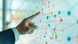© Plaifah - A hand pointing at a whiteboard with a diagram of interconnected nodes and arrows