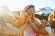 © maxbelchenko - Holi festival. Group of friends having fun at the beach party. Friendship, rest, holidays.