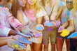 © maxbelchenko - Holi festival. Group of friends having fun at the beach party. Friendship, rest, holidays.