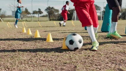 Canvas Print - Boy, ball and training for soccer on field with coaching, kick and running in cone with fitness. Football club, child and legs for match workout, drill and player on grass for sport and exercise