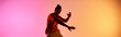 © LIGHTFIELD STUDIOS - A young African American man in an orange shirt dances against a colorful gradient background.