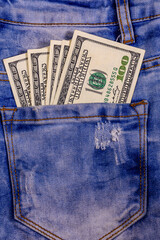 Wall Mural - American one hundred dollar banknotes in a pocket of blue jeans