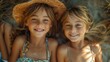 © fotofabrika - Two Smiling Young Girls Lying in Grass on a Sunny Day