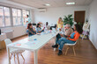 © ADDICTIVE STOCK - Diverse team engaging in collaborative work in modern office