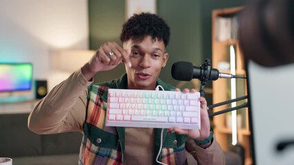 Poster - Camera, influencer and man with product, talking and keyboard in living room with mic for advertising. Home, feedback and content creation for blogger for gaming equipment, online and promotion