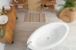 © Pixel-Shot - Stylish bathroom with bathtub, chest of drawers, shelving unit and sink