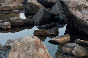 Poster - Majestic rock formations against a backdrop of crystalclear blue water, sunny skies, and serene beauty