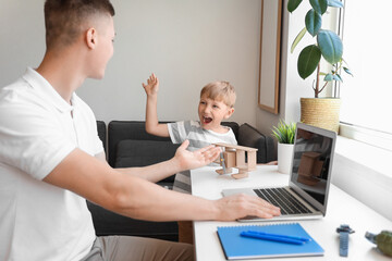 Sticker - Naughty little boy with his working father at home