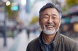 © Anastasija - Senior Asian Man Smiling Outdoors - Positive Energy, Urban Lifestyle, Joyful Expression
