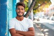 © Anastasija - Handsome Latin Man Smiling with Crossed Arms - Confident Pose, Positive Personality, and Urban Style