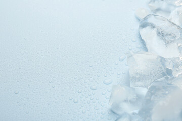 Wall Mural - Pieces of crushed ice on light blue background, space for text