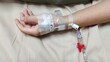 © Rung Kh - portrait showing the patient lying on the bed, Saline in hand and during lying rehabilitation in the hospital, health care and medical concept.