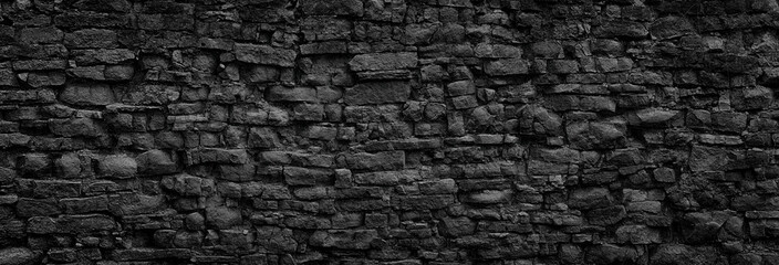 Wall Mural - black stone wall, gloomy stonework texture as background