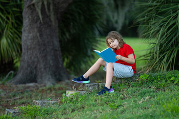 Aufkleber - Child read a book. Elementary outdoor school. Early education for children. Summer vacation homework. Little student outdoor. Children and education concept. Child having picnic in summer park.