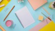 © Oksana - Spiral notebook surrounded by pastel stationery items
