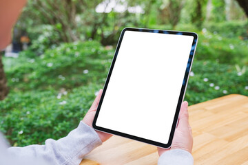 Poster - Mockup image of a woman holding digital tablet with blank white desktop screen in the outdoors