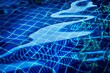 © SAKCHAI - The image is of a pool with blue water and a blue net