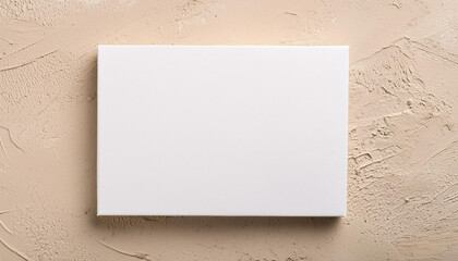 Wall Mural - Blank rectangular white poster on beige surface, mock-up for design presentations and portfolios.