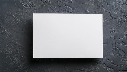 Wall Mural - Blank rectangular white poster on dark gray surface, mock-up for design presentations and portfolios